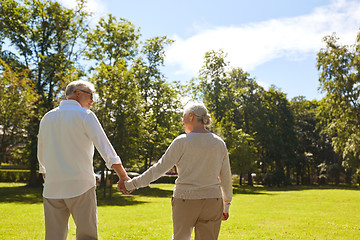 Image showing happy senior couple walking at summer park