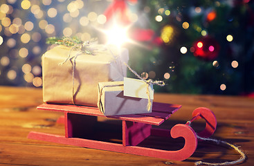 Image showing close up of christmas gift boxes on wooden sleigh