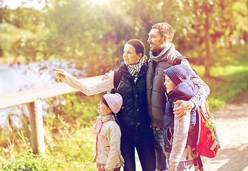 Image showing happy family with backpacks hiking