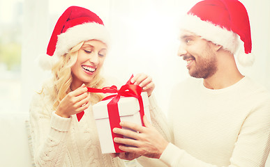 Image showing happy couple at home with christmas gift box