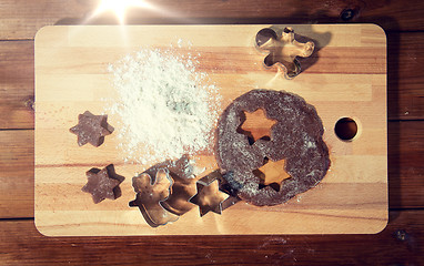 Image showing close up of ginger dough, molds and flour on board