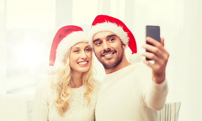 Image showing couple taking selfie with smartphone at christmas