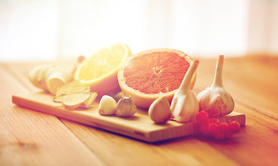 Image showing citrus, ginger, garlic and rowanberry on wood