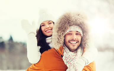 Image showing happy couple having fun over winter background