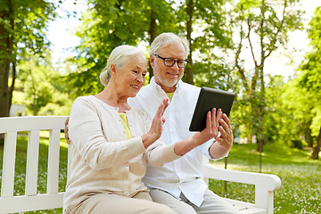 Image showing happy senior couple with tablet pc at summer park