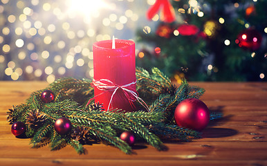 Image showing fir branch wreath with candle on wooden table