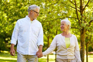 Image showing happy senior couple walking at summer park