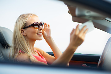 Image showing woman in convertible car taking selfie