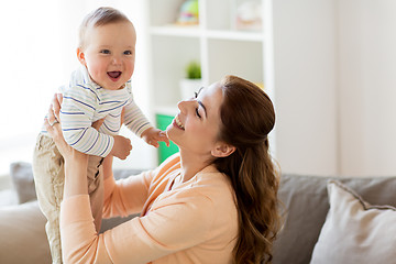 Image showing happy young mother with little baby at home