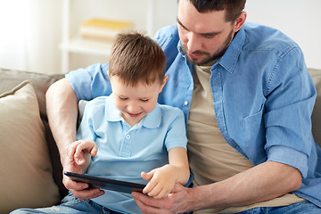 Image showing father and son with tablet pc playing at home