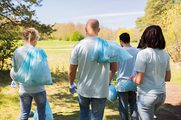 Image showing group of volunteers with garbage bags in park