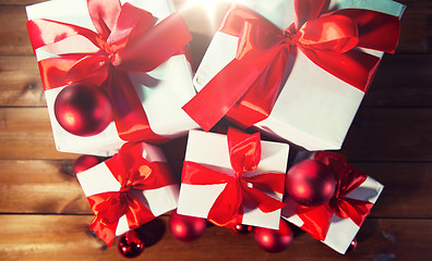 Image showing close up of gift boxes and red christmas balls