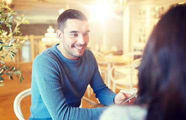 Image showing happy couple talking at cafe or restaurant