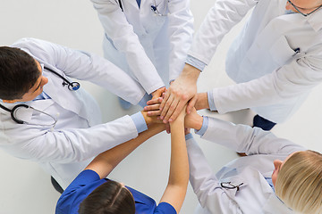 Image showing group of doctors with hands together at hospital