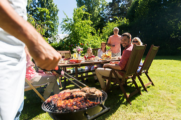 Image showing man cooking meat on barbecue grill at summer party