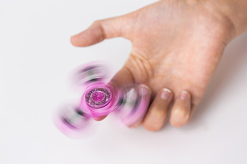 Image showing close up of hand playing with fidget spinner