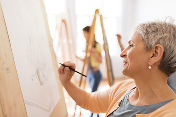 Image showing woman artist with pencil drawing at art school