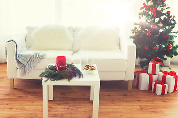 Image showing sofa, table and christmas tree with gifts at home