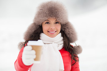 Image showing happy woman in winter fur hat with coffee outdoors