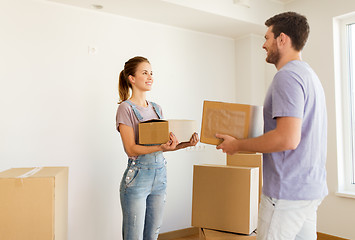 Image showing happy couple with boxes moving to new home