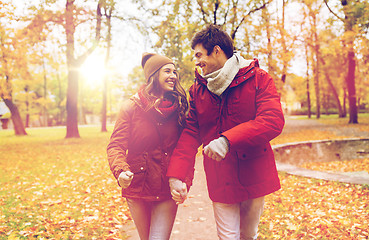 Image showing happy young couple walking in autumn park