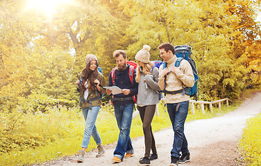 Image showing group of smiling friends with backpacks hiking