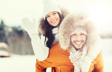 Image showing happy couple having fun over winter background