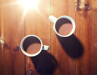Image showing cups of hot chocolate or cocoa drinks on wood