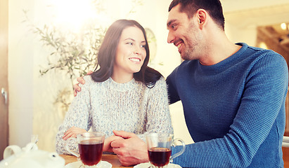 Image showing happy couple drinking tea at restaurant