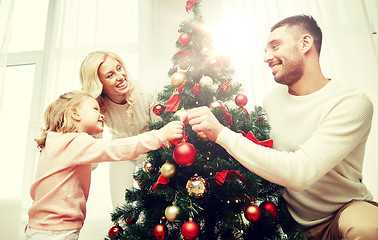 Image showing happy family decorating christmas tree at home