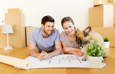 Image showing couple with boxes, blueprint and dog at new home