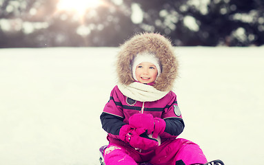 Image showing happy little kid on sled outdoors in winter