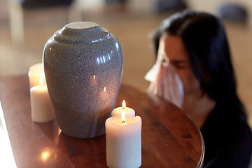 Image showing woman with cremation urn at funeral in church