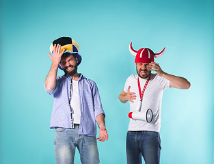 Image showing The two football fans over blue