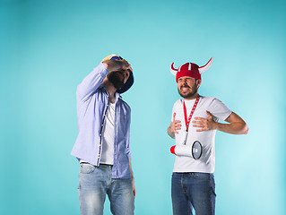 Image showing The two football fans over blue