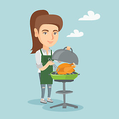 Image showing Caucasian woman cooking chicken on the barbecue.