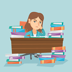 Image showing Student sitting at the table with piles of books.