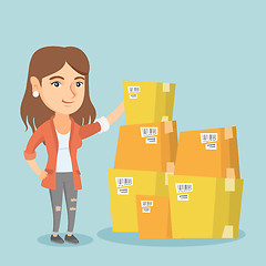 Image showing Young business woman checking boxes in warehouse.