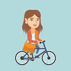 Image showing Young caucasian business woman riding bicycle.