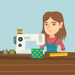 Image showing Seamstress using a sewing machine at the workshop.