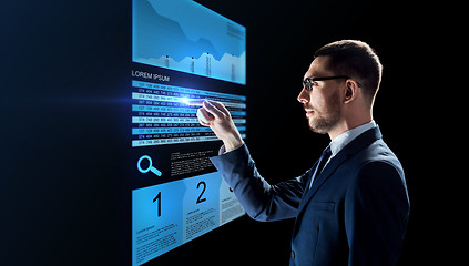 Image showing businessman with stock charts on virtual screens