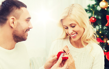 Image showing man giving woman engagement ring for christmas