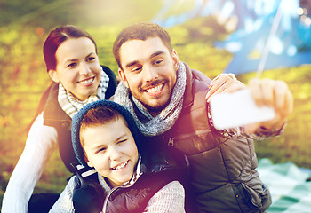 Image showing family with smartphone taking selfie at campsite