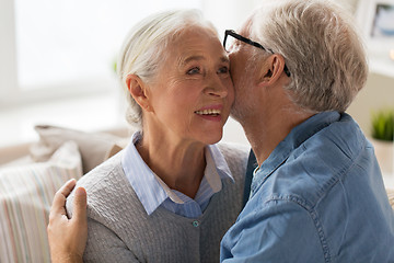 Image showing happy senior couple hugging at home