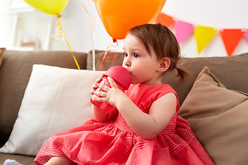 Image showing baby girl drinking from sippy cup at birthday