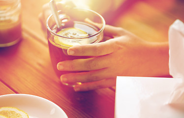 Image showing close up of ill woman drinking tea with lemon