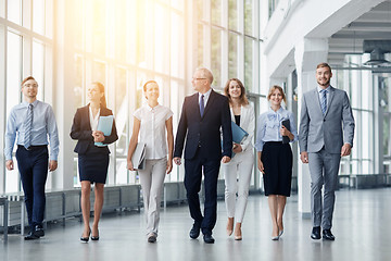 Image showing business people walking along office building