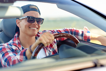 Image showing happy young man in shades driving convertible car