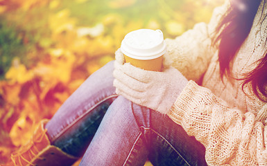 Image showing close up of woman drinking coffee in autumn park