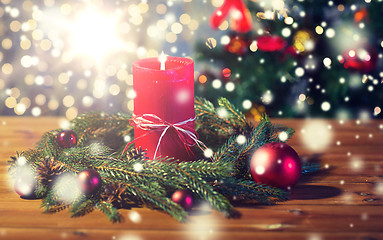 Image showing fir branch wreath with candle on wooden table